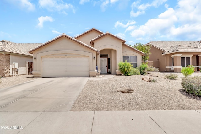 871 N Granada Dr, Chandler, AZ 85226 - mediterranean / spanish-style home featuring stucco siding, an attached garage, concrete driveway, and a tiled roof