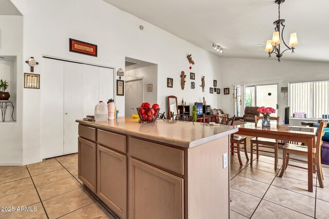 871 N Granada Dr, Chandler, AZ 85226 - kitchen with lofted ceiling, light tile patterned flooring, a center island, decorative light fixtures, and open floor plan