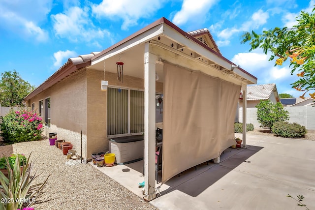 871 N Granada Dr, Chandler, AZ 85226 - view of home's exterior featuring stucco siding, fence, a patio area, and a tiled roof