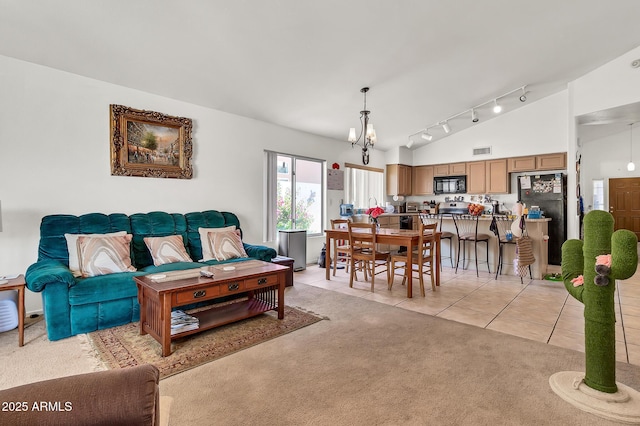 871 N Granada Dr, Chandler, AZ 85226 - living area with lofted ceiling, rail lighting, light colored carpet, a chandelier, and light tile patterned floors