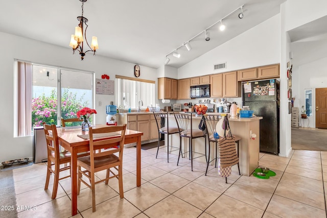 871 N Granada Dr, Chandler, AZ 85226 - dining room featuring track lighting, a chandelier, light tile patterned flooring, and high vaulted ceiling