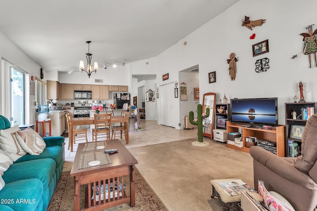 871 N Granada Dr, Chandler, AZ 85226 - living room with a chandelier, high vaulted ceiling, light tile patterned floors, light carpet, and track lighting