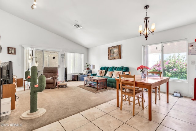 871 N Granada Dr, Chandler, AZ 85226 - dining space featuring light carpet, vaulted ceiling, light tile patterned flooring, and a chandelier