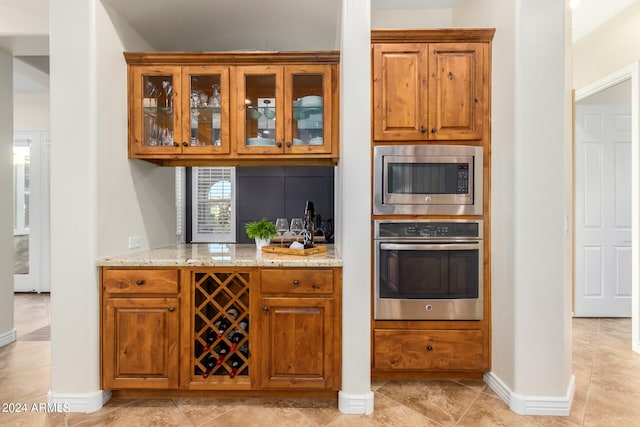 kitchen with light stone countertops and stainless steel appliances