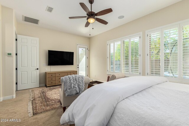 bedroom featuring light carpet and ceiling fan