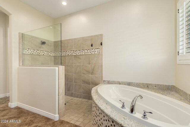 bathroom featuring tile patterned flooring and independent shower and bath