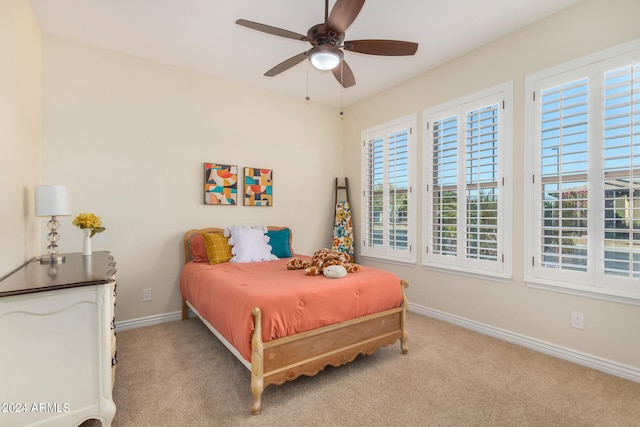 bedroom featuring light colored carpet and ceiling fan