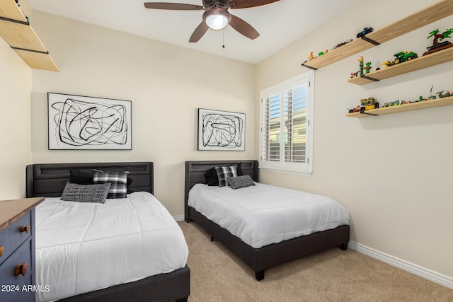 bedroom with ceiling fan and light carpet