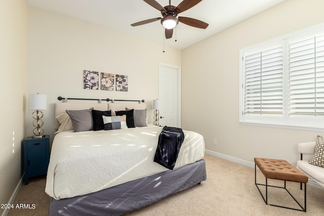 bedroom featuring ceiling fan and light carpet