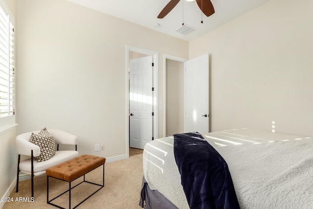 bedroom with ceiling fan and light colored carpet