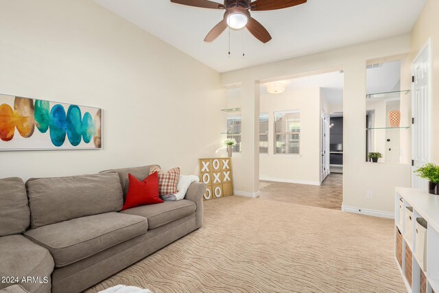 carpeted living room with ceiling fan