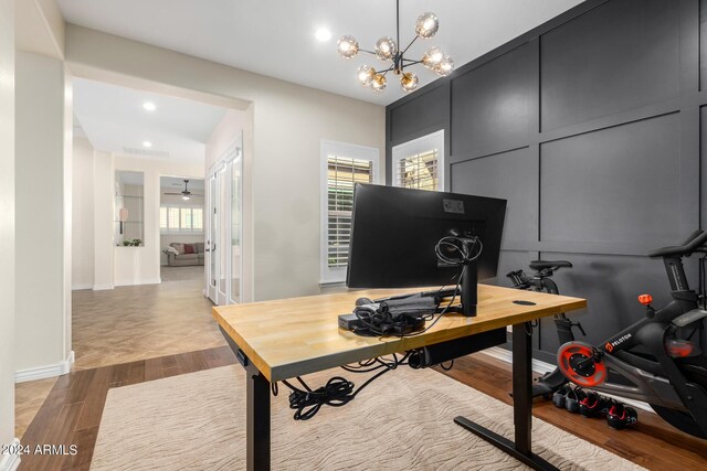 office with ceiling fan with notable chandelier