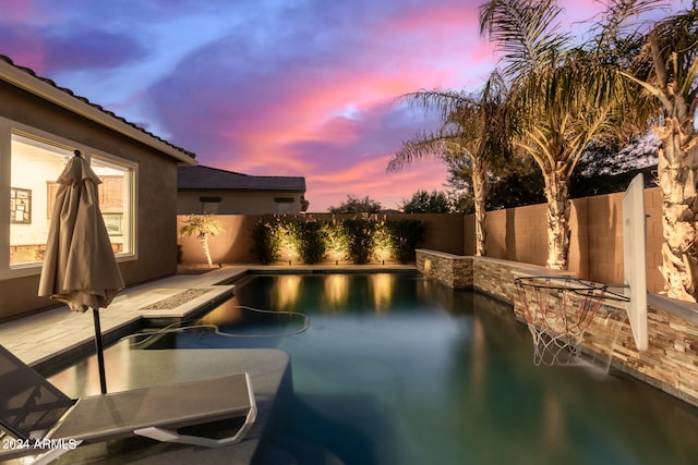 view of pool at dusk