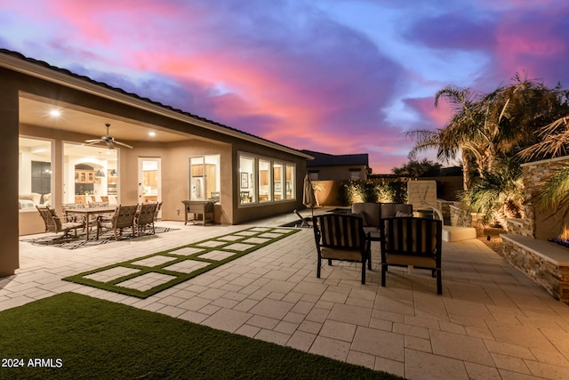 patio terrace at dusk featuring ceiling fan