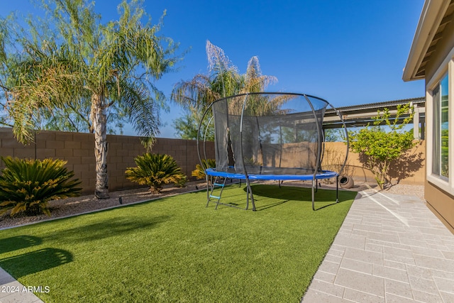 view of yard with a trampoline