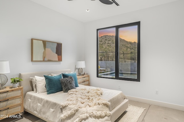 bedroom with a mountain view and ceiling fan