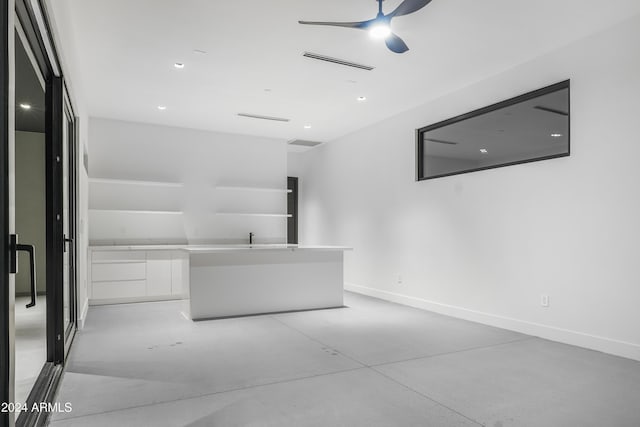 interior space with concrete floors and ceiling fan