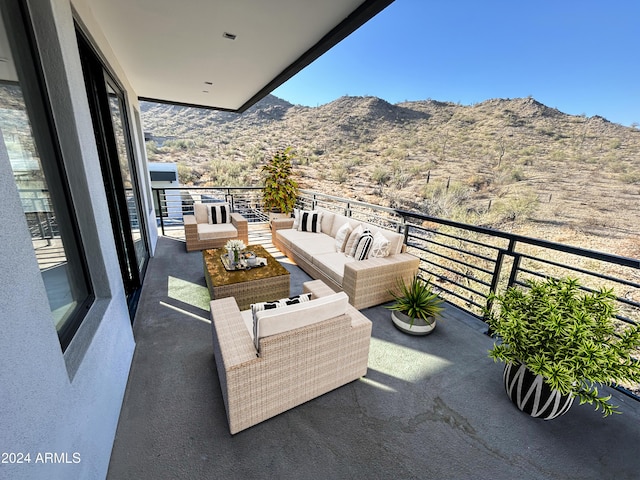 balcony with a mountain view and an outdoor hangout area