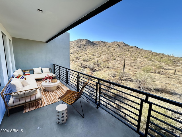 balcony with a mountain view and an outdoor hangout area