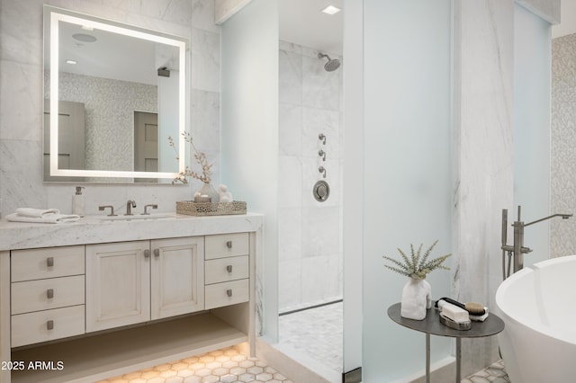 bathroom with vanity and shower with separate bathtub