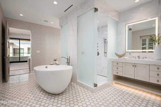 bathroom with vanity and separate shower and tub