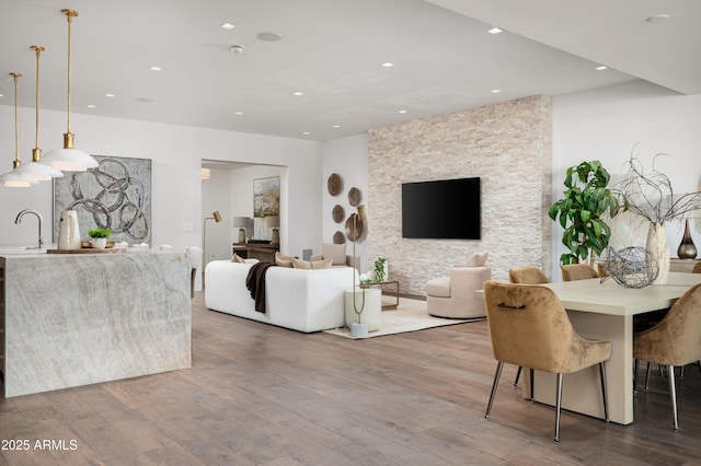 living room featuring hardwood / wood-style floors and sink