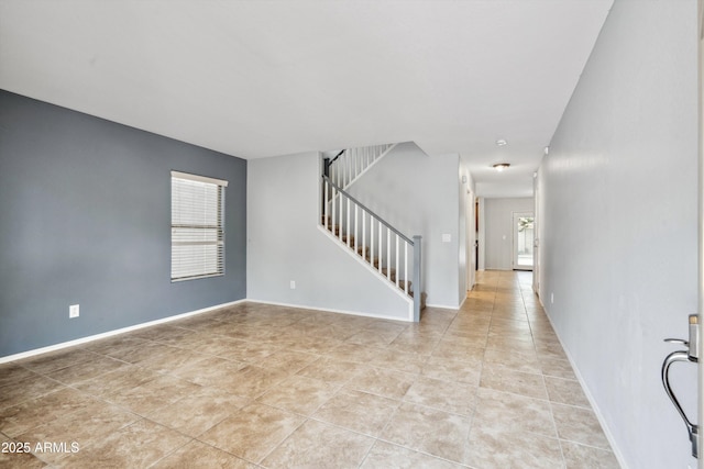 foyer entrance featuring stairway and light tile patterned flooring