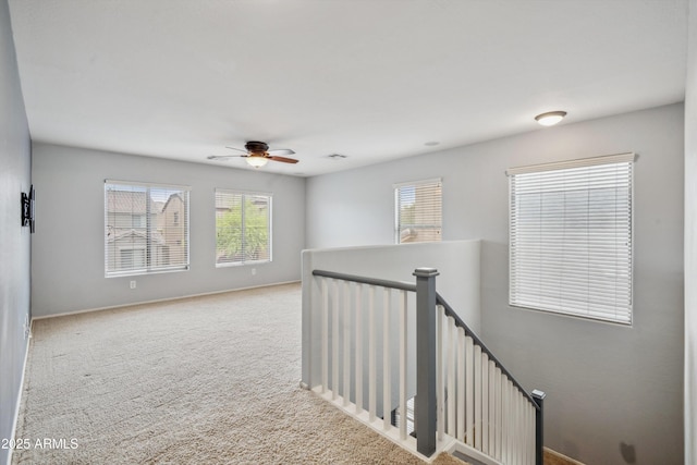 unfurnished room with ceiling fan, carpet, and baseboards