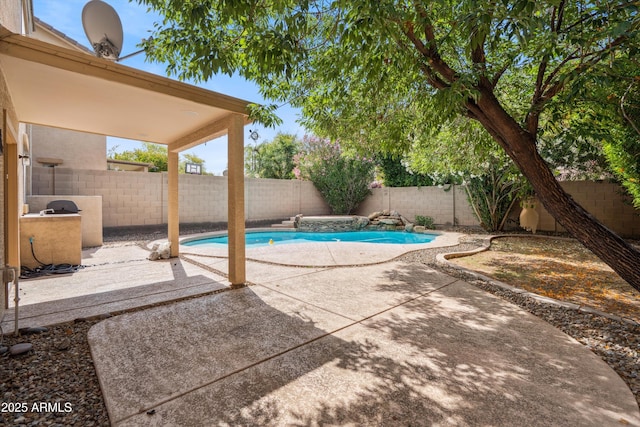 view of swimming pool with a patio and a fenced backyard