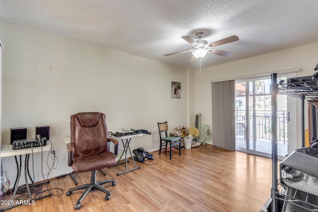 sitting room featuring baseboards, a textured ceiling, ceiling fan, and wood finished floors