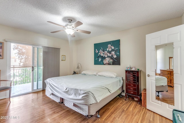 bedroom featuring a textured ceiling, a ceiling fan, light wood-style flooring, and access to exterior