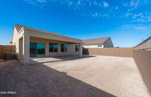 rear view of house with a patio and central AC