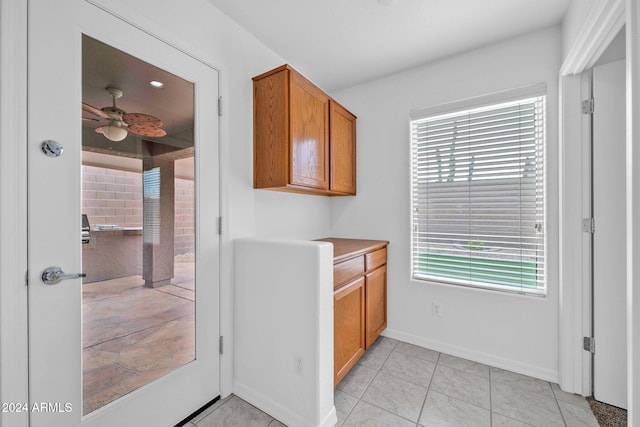 kitchen with light tile patterned floors and ceiling fan