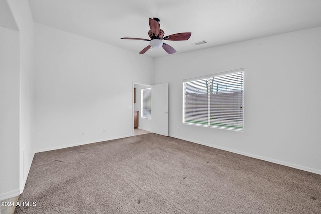 carpeted spare room featuring ceiling fan