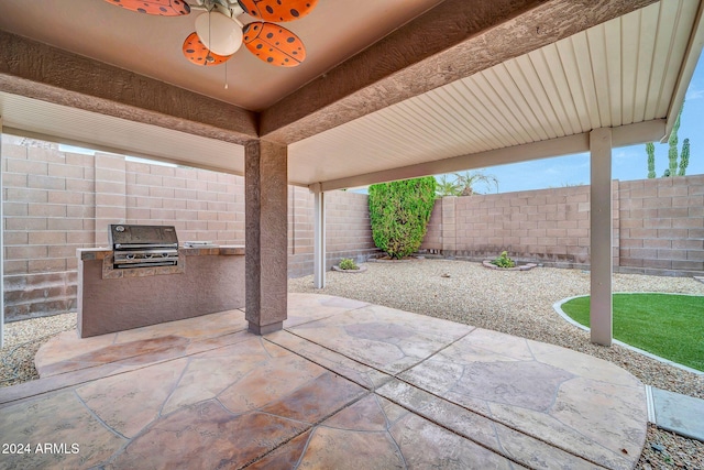 view of patio / terrace with area for grilling and ceiling fan