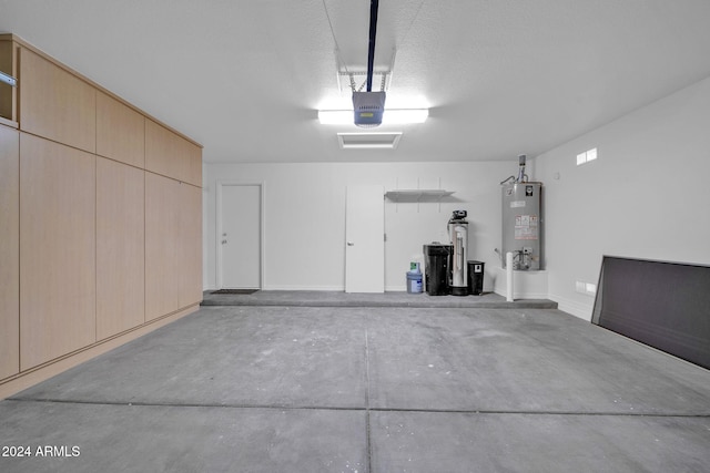 garage featuring a garage door opener and water heater