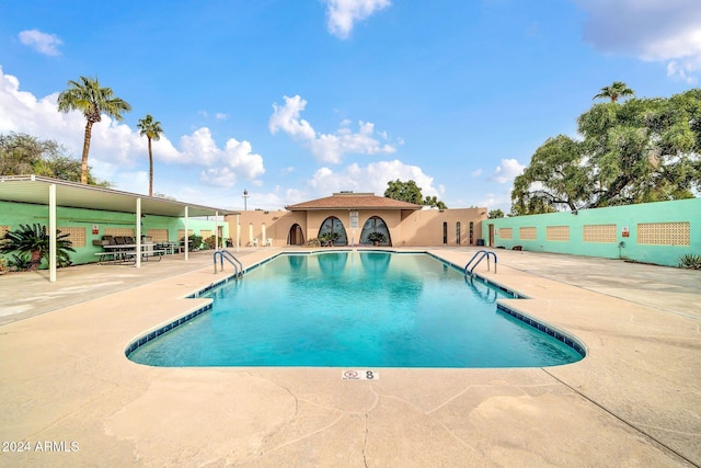 view of swimming pool featuring a patio area