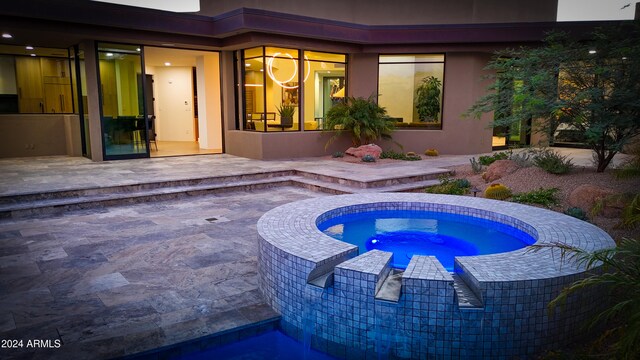 view of swimming pool featuring an in ground hot tub and a patio area