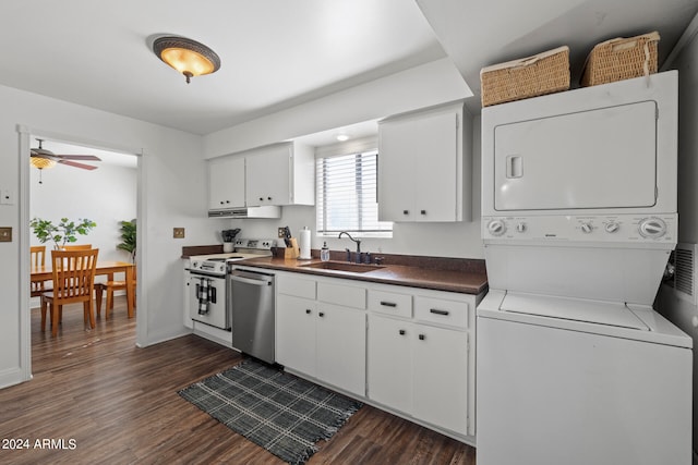 kitchen featuring white cabinets, dark hardwood / wood-style floors, stainless steel appliances, sink, and stacked washer and clothes dryer