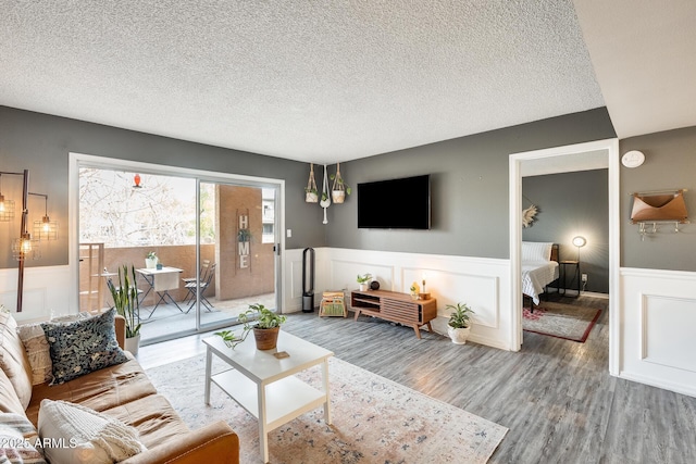 living room with hardwood / wood-style flooring and a textured ceiling