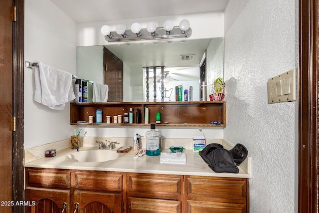 940 S Revere, Mesa, AZ 85210 - bathroom featuring a textured wall, vanity, and a ceiling fan