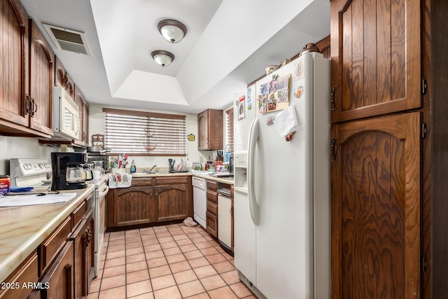 940 S Revere, Mesa, AZ 85210 - kitchen featuring white appliances, light countertops, light tile patterned floors, a tray ceiling, and a sink