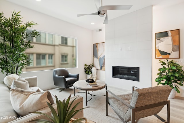 5250 E Deer Valley Dr Unit 140, Phoenix, AZ 85054 - living area with a ceiling fan, recessed lighting, wood finished floors, and a tiled fireplace