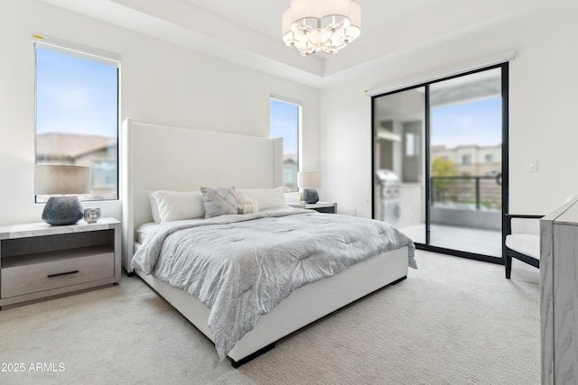 5250 E Deer Valley Dr Unit 140, Phoenix, AZ 85054 - bedroom featuring a chandelier, access to exterior, and light colored carpet