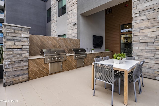5250 E Deer Valley Dr Unit 140, Phoenix, AZ 85054 - view of patio / terrace featuring exterior kitchen and outdoor dining area
