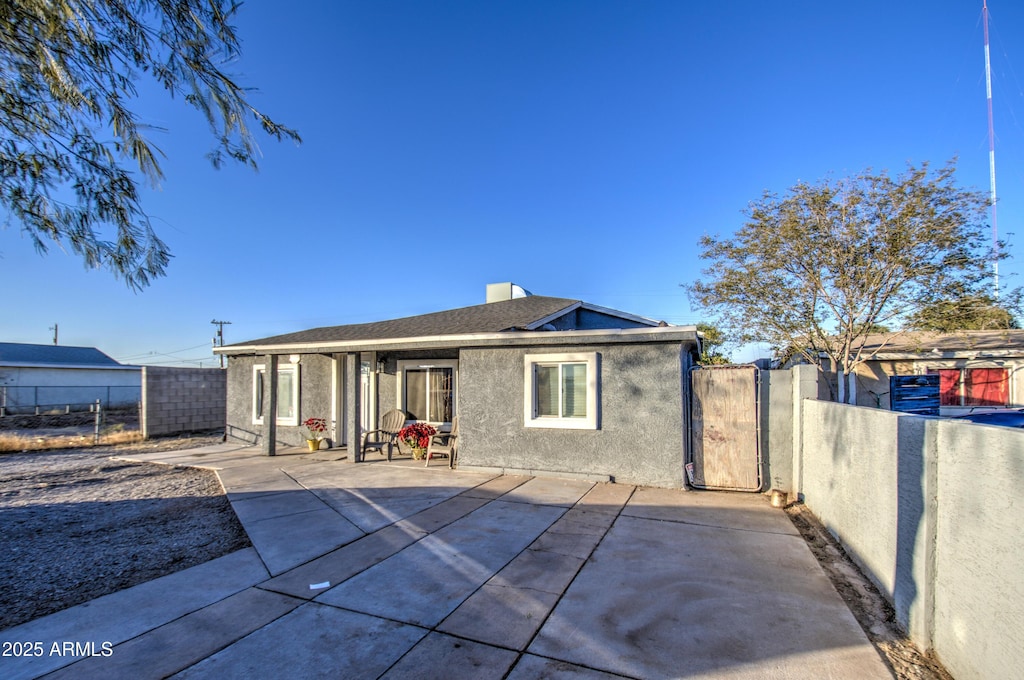 rear view of property featuring a patio area