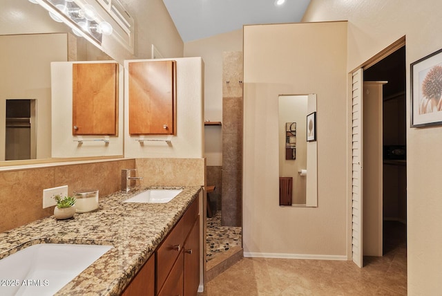 full bathroom featuring tile patterned flooring, a sink, a walk in shower, and double vanity