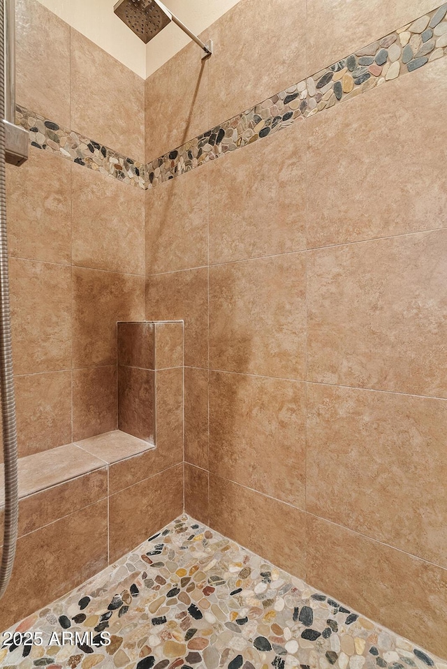 full bath featuring a tile shower