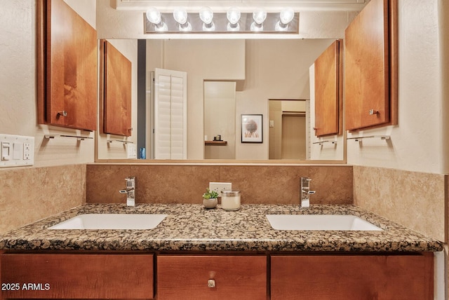 bathroom with backsplash, double vanity, tile walls, and a sink