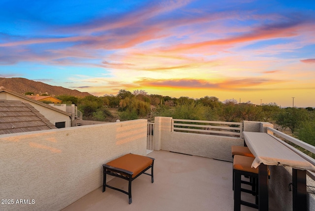 view of patio / terrace featuring a mountain view and a balcony